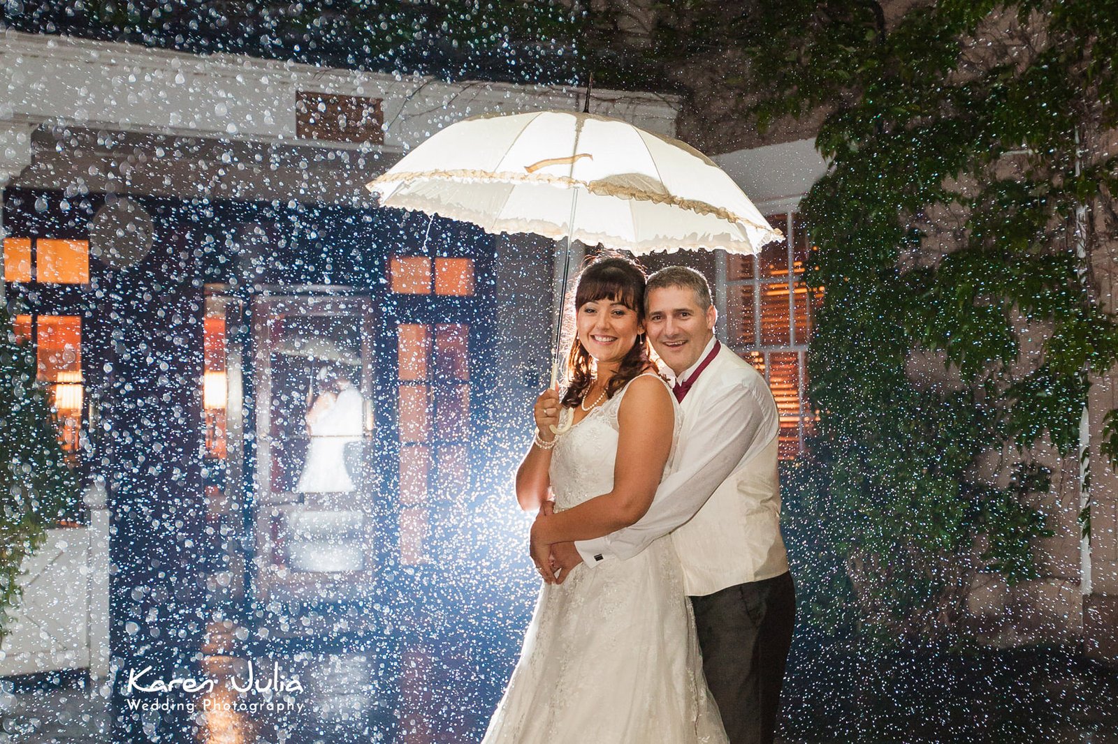 bride & groom portrait in rain by karen julia