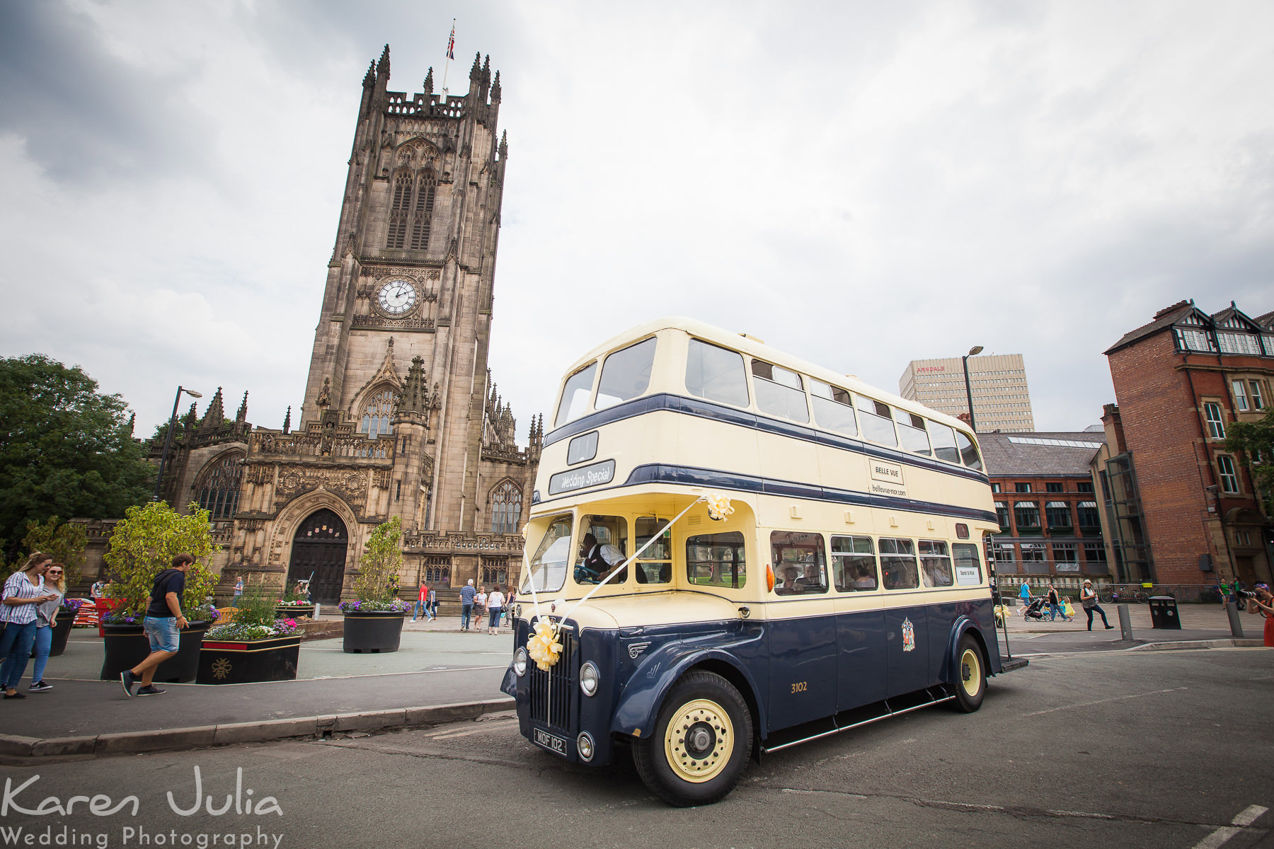 bride arrives on vintage bus at Manchester Cathedral 