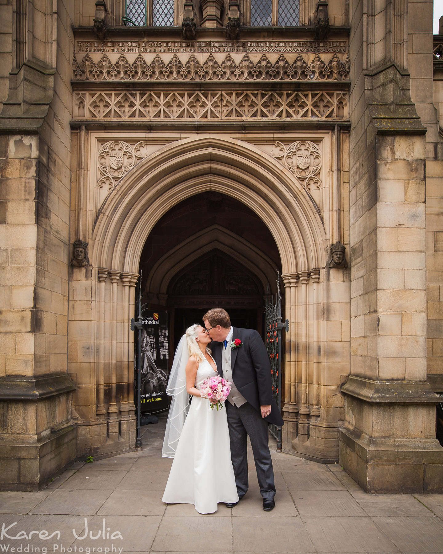 bride and groom kiss after leaving Manchester Cathedral