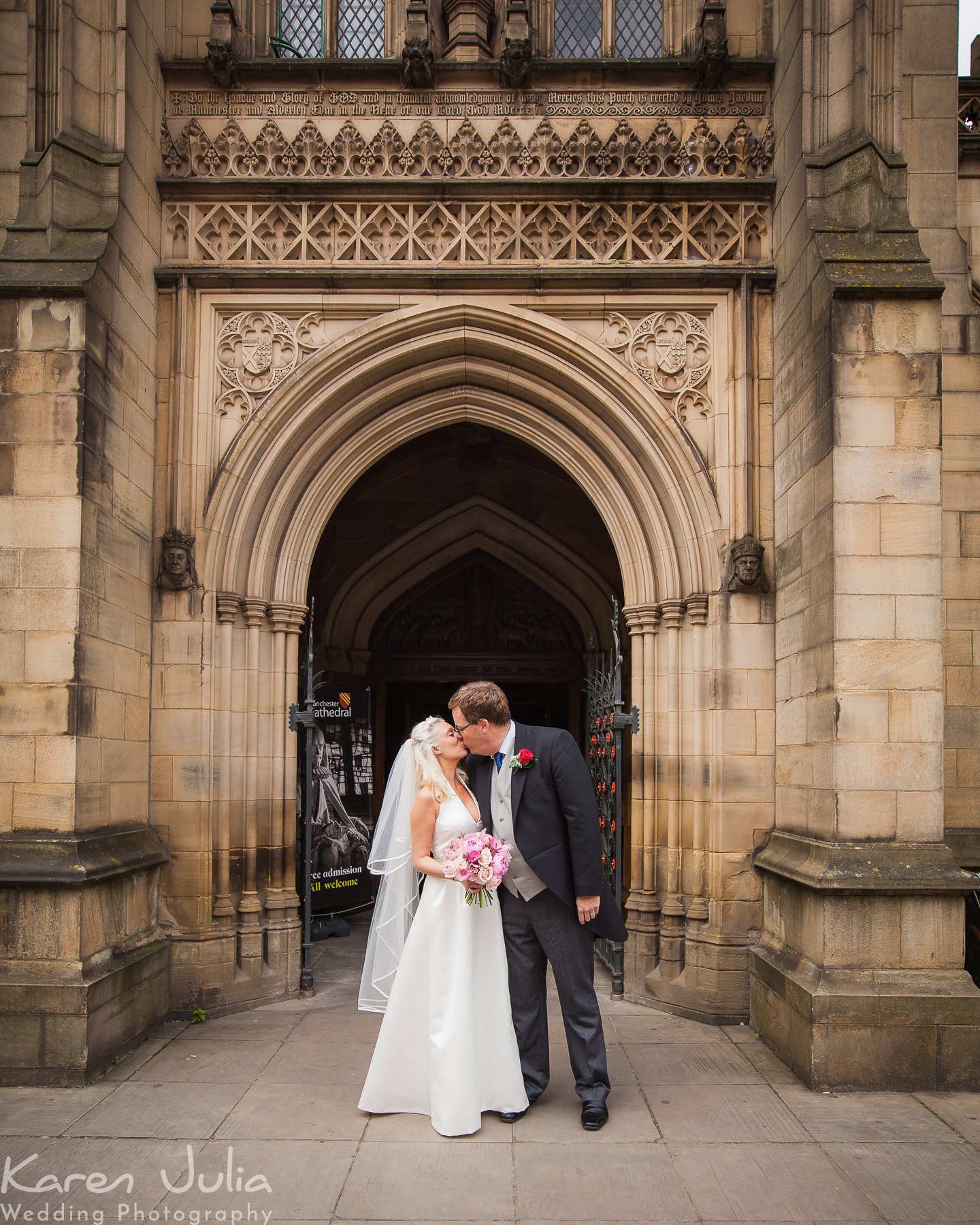 bride and groom kiss after leaving Manchester Cathedral