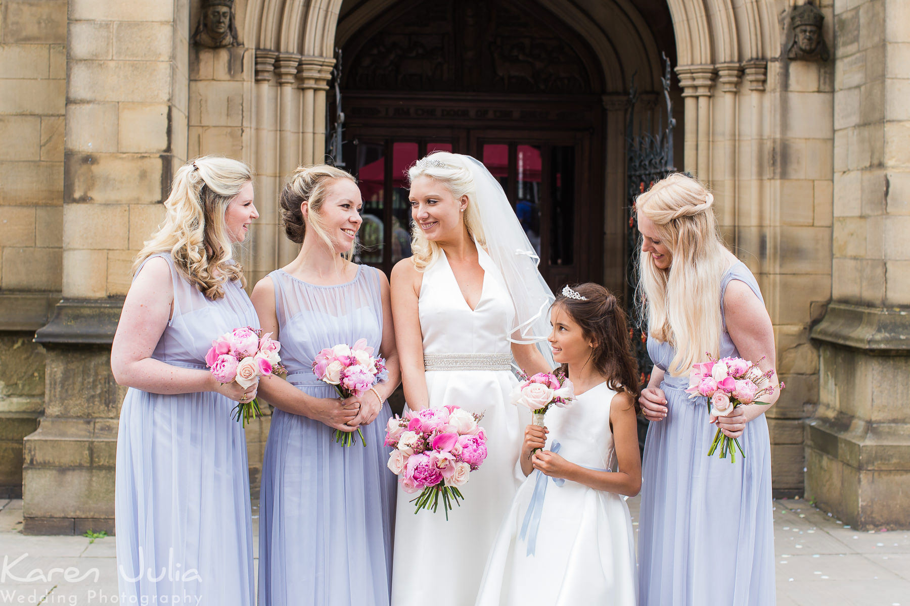 bride with bridesmaids outside Manchester Cathedral
