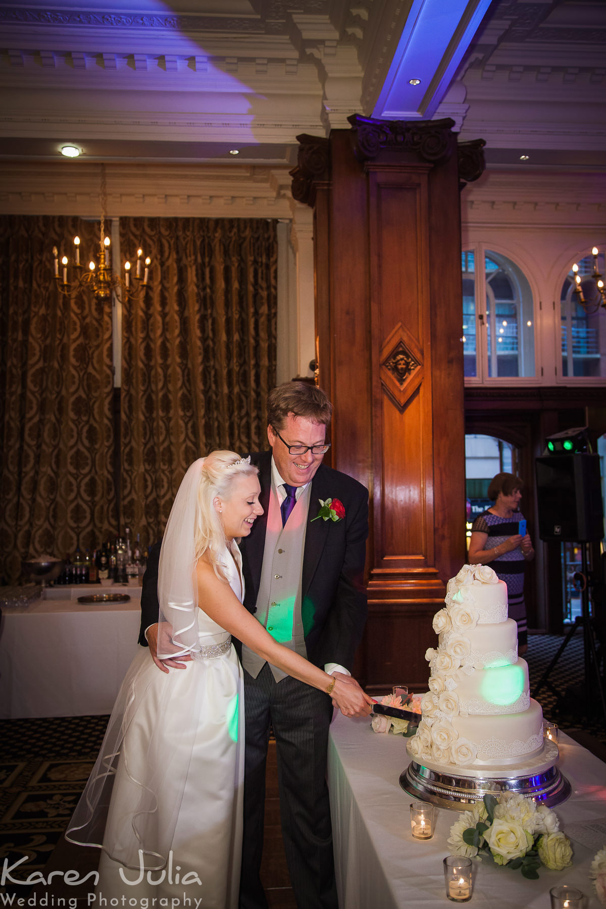 bride and groom cut the cake at their wedding reception