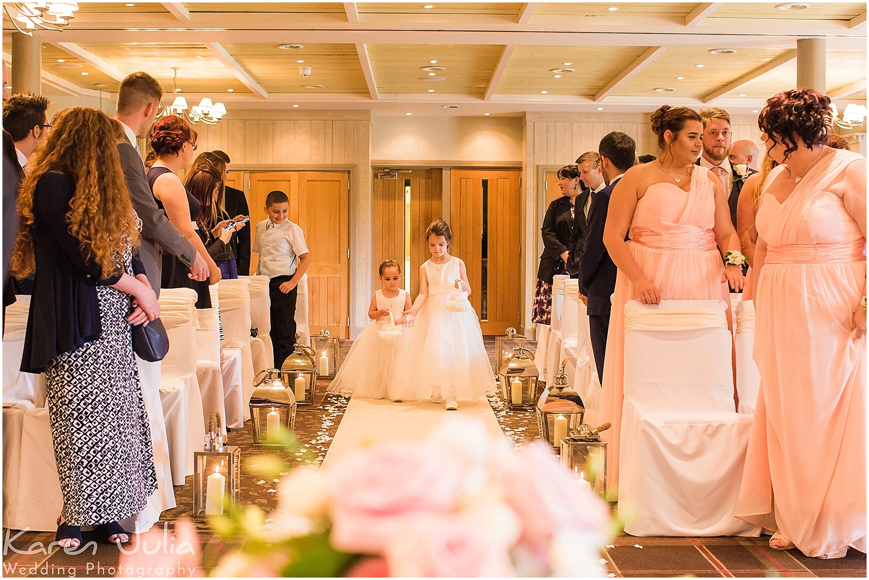 flower girls walk down the aisle at Stanley House Hotel