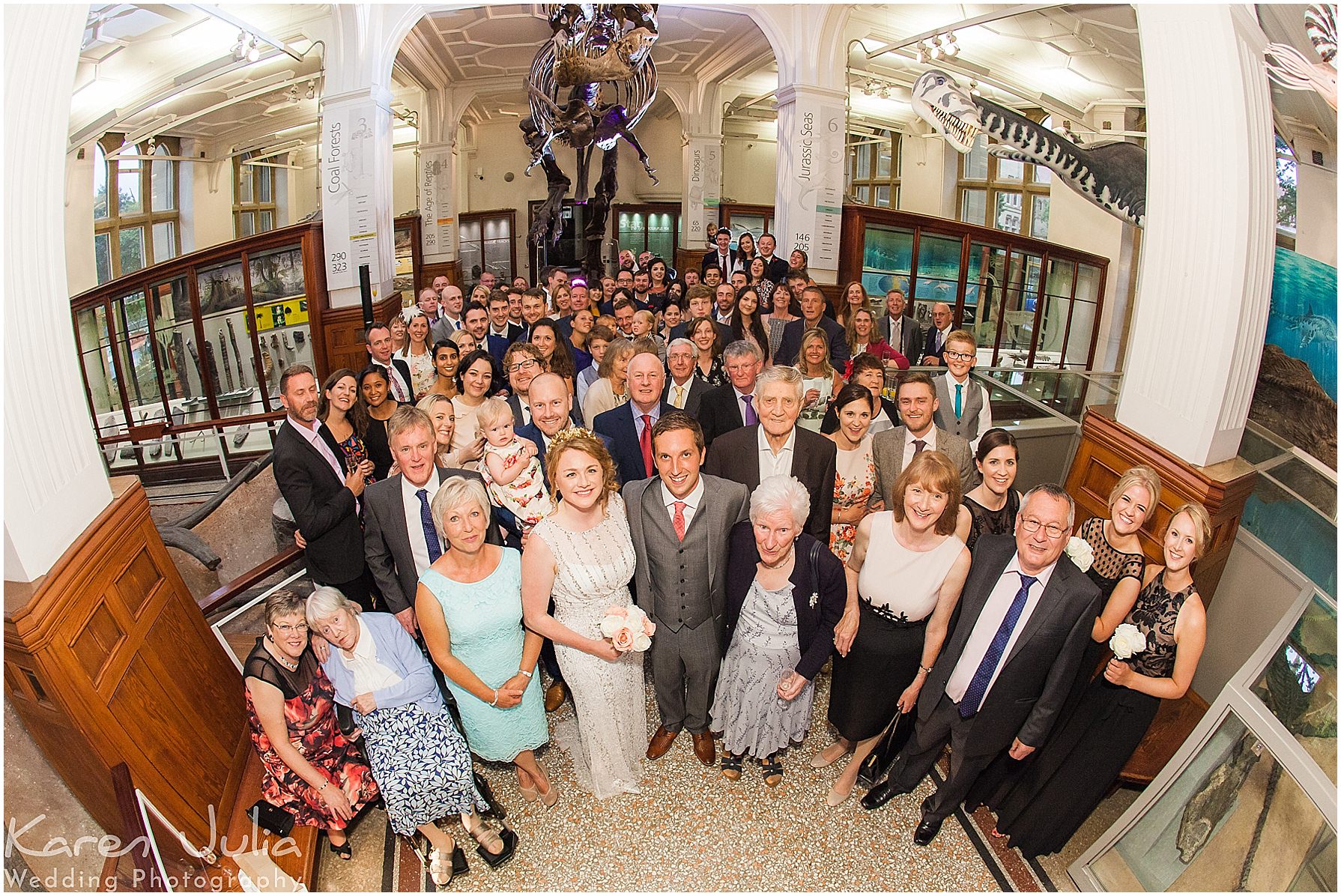 group photo of all wedding guests in the fossil room with T-Rex Stan