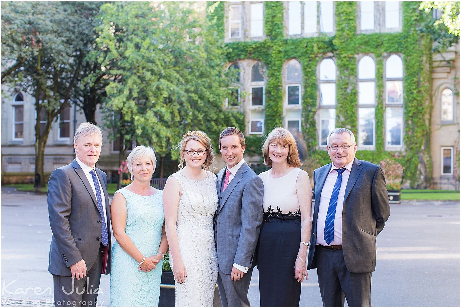 group photo of bride and groom with parents in the courtyard at Manchester Museum