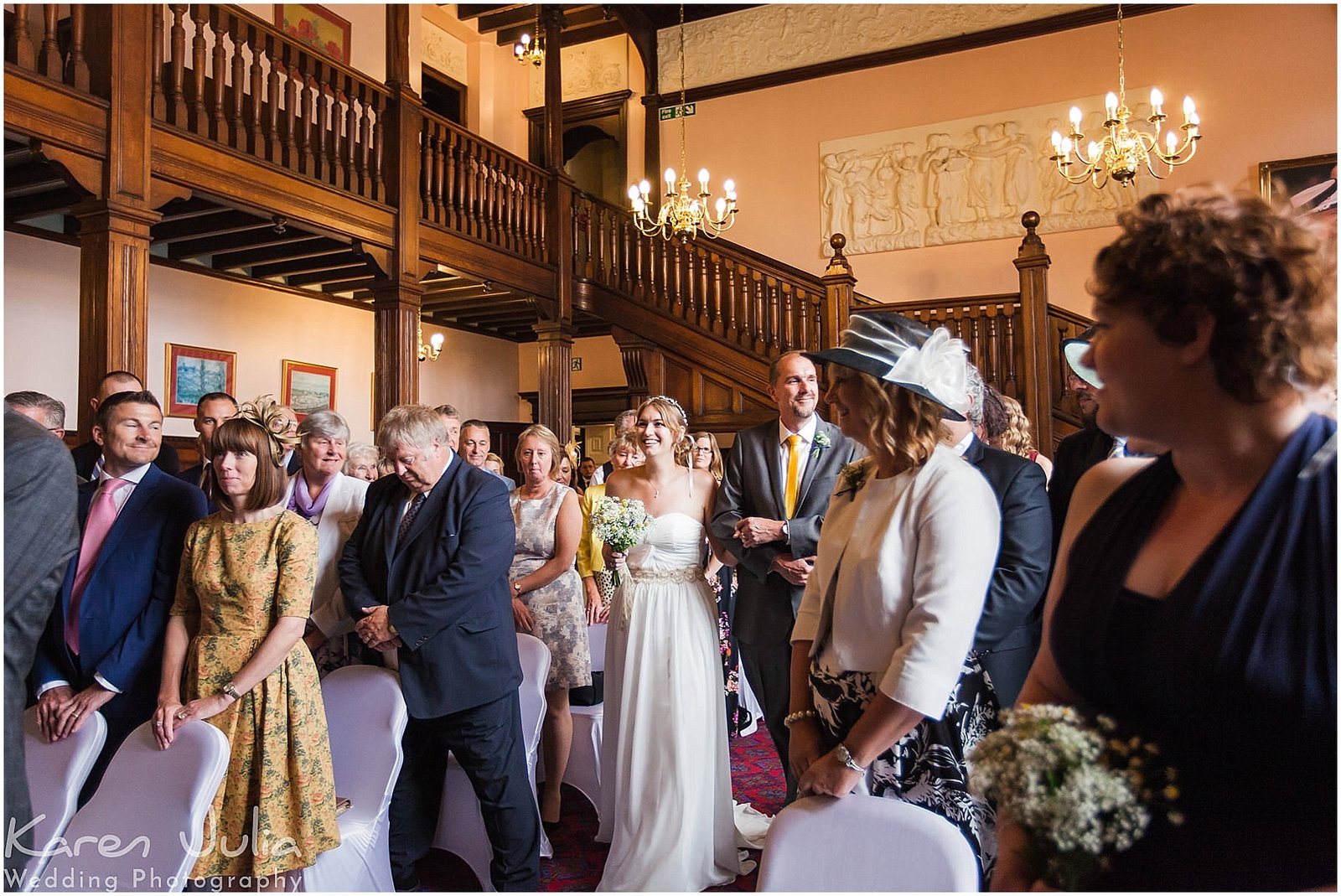 bride walks down aisle at wedding ceremony at Reese Heath Hall