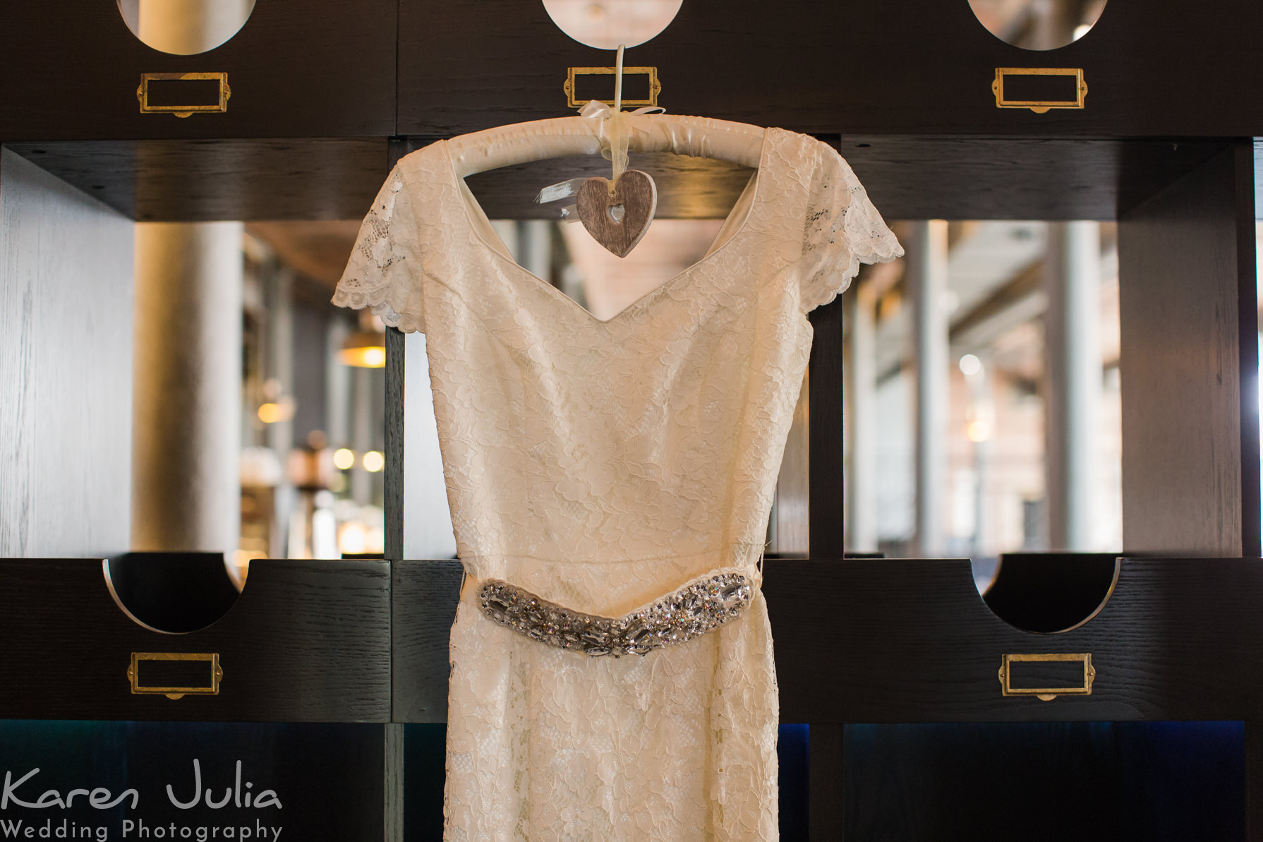brides dress hung up in reception at the Titanic Hotel & Hard Day's Night Wedding
