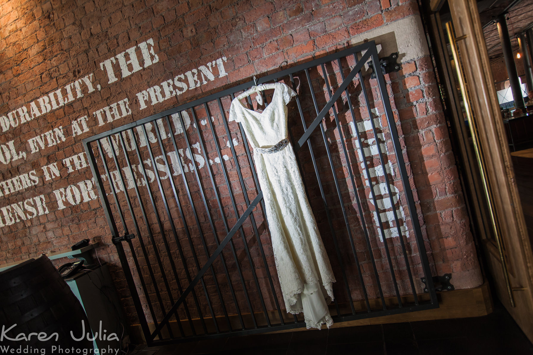 brides dress hung up over gate in the reception of the Titanic hotel