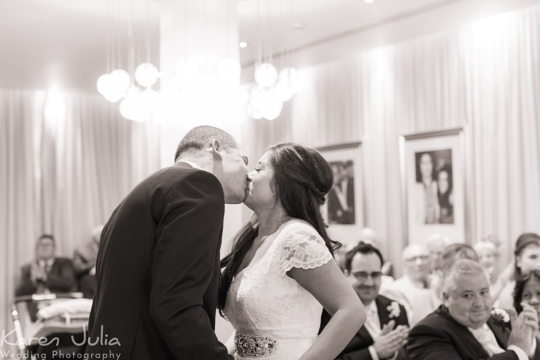 bride and groom kiss during wedding ceremony in the Two Of Us suite