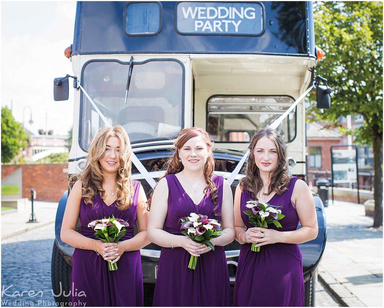 bridesmaids in dark purple dresses with black and cream vintage bus