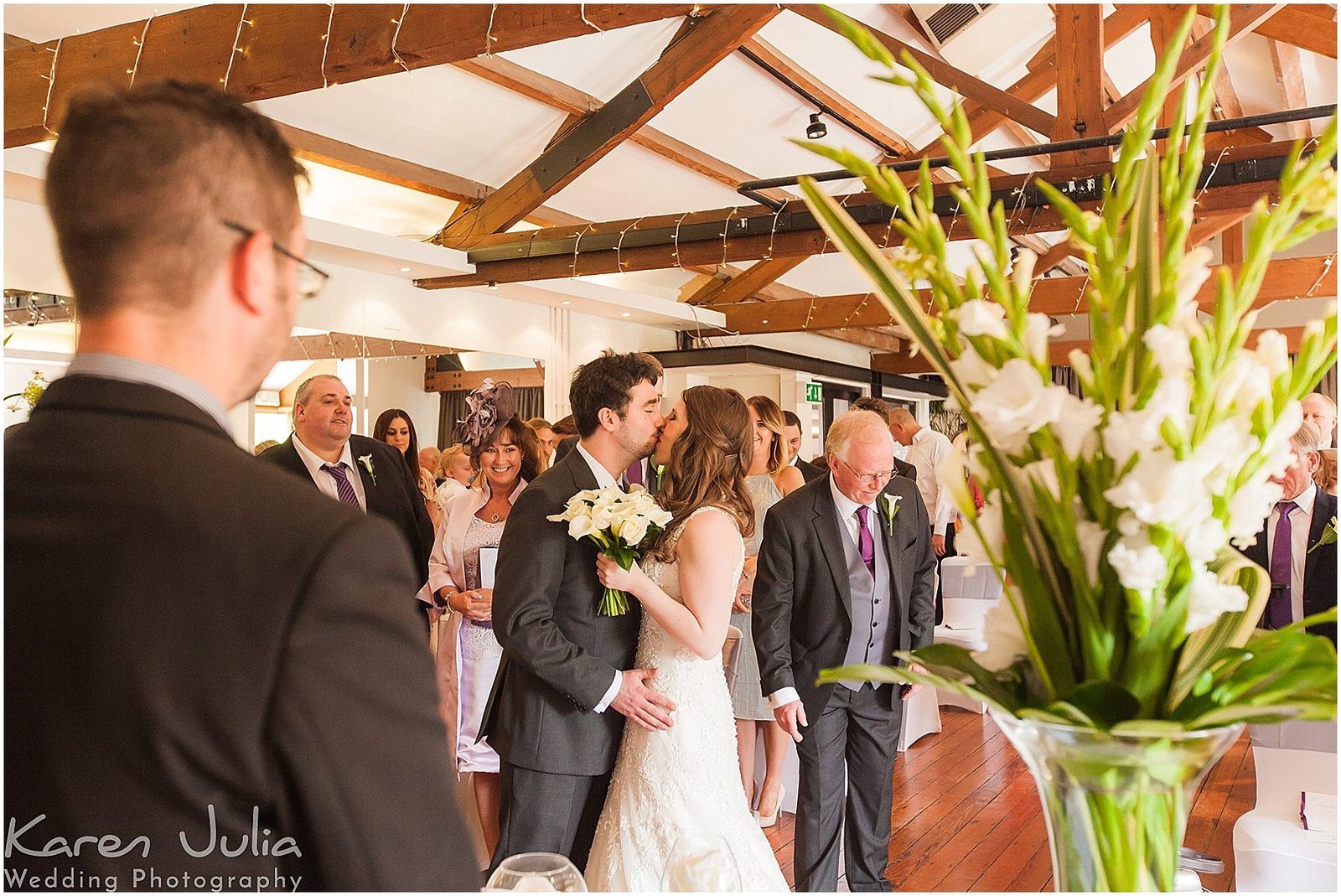 bride and groom kiss during wedding ceremony in the Brindley room