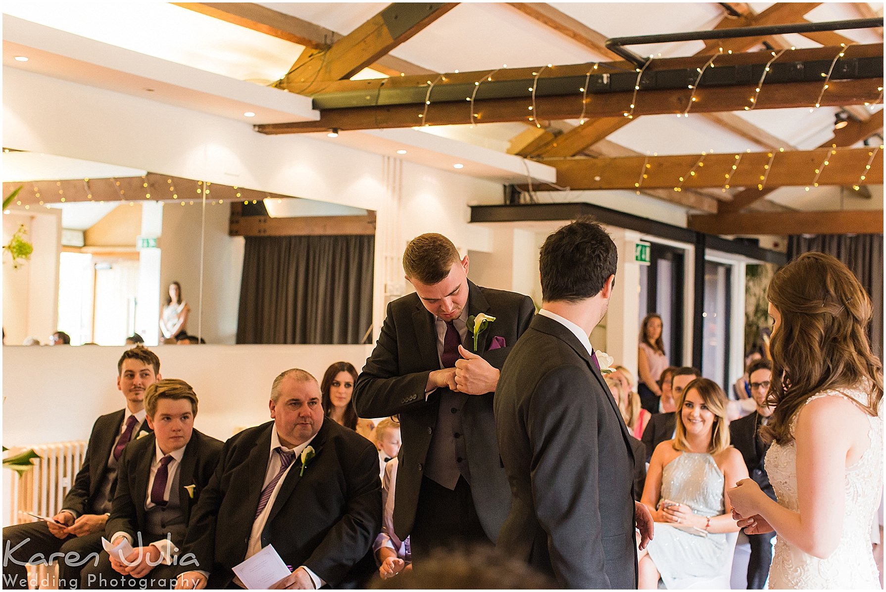best man looks for rings during wedding ceremony at Castlefield Rooms