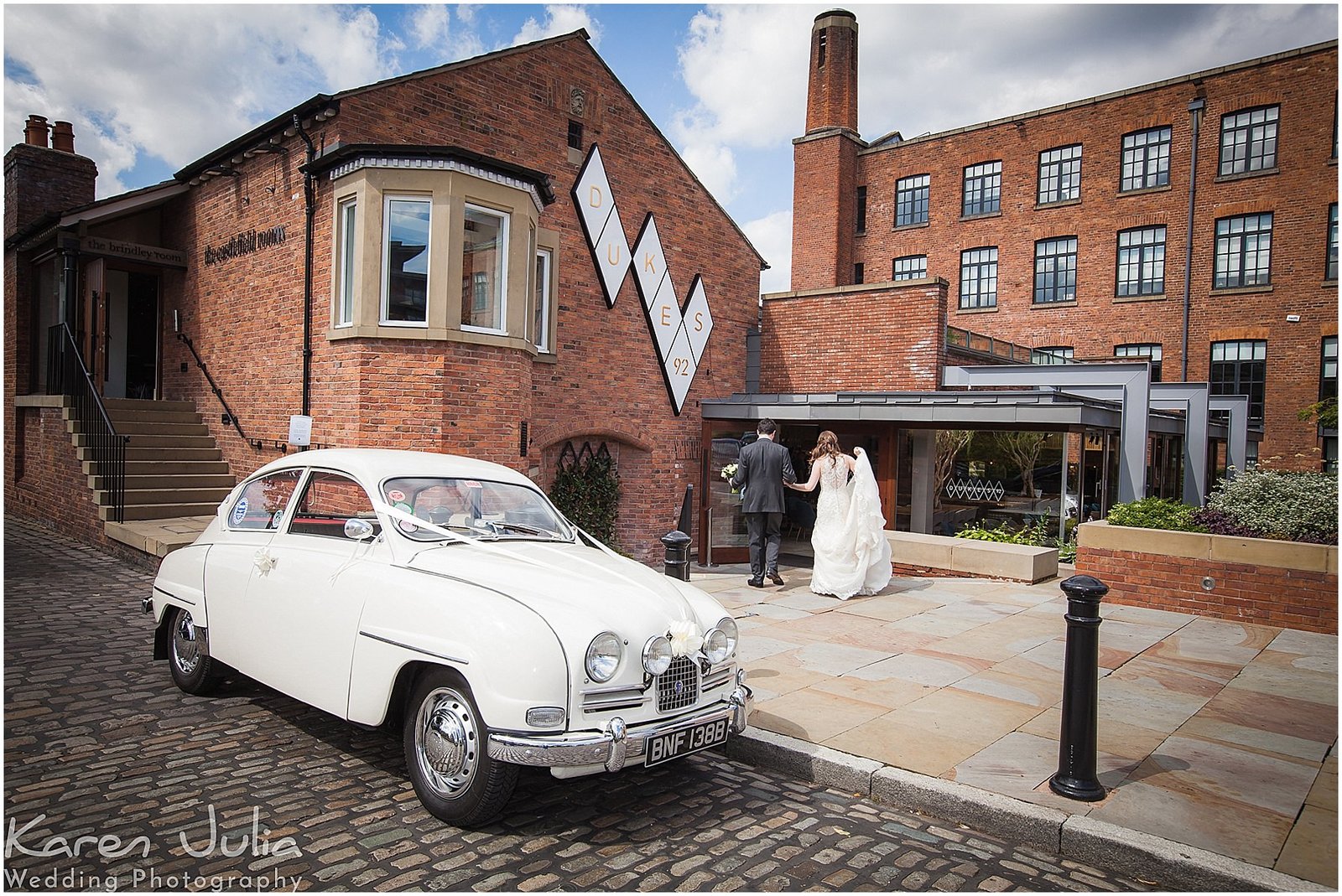 vintage SAAB with bride nd groom in background