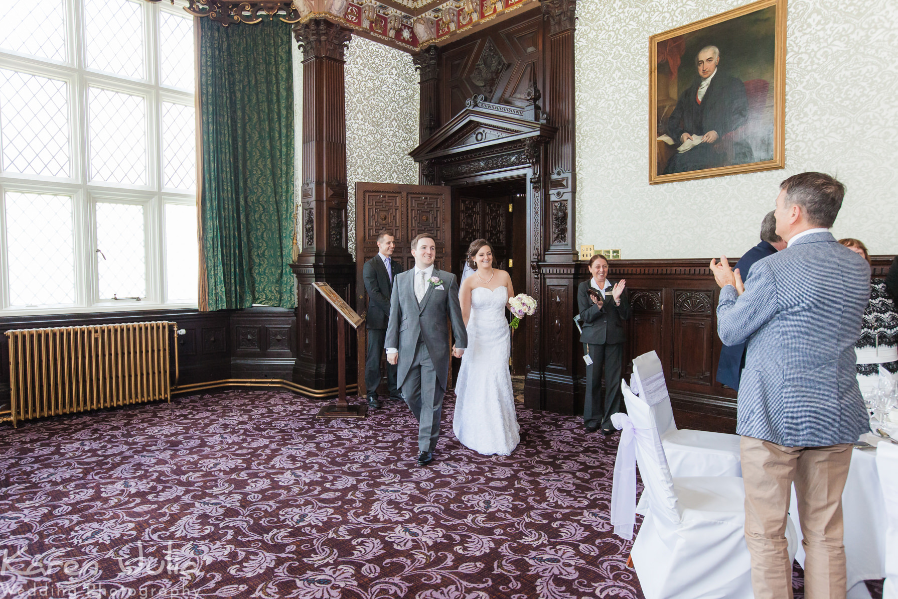 bride and groom make their entrance to wedding breakfast room at Crewe Hall