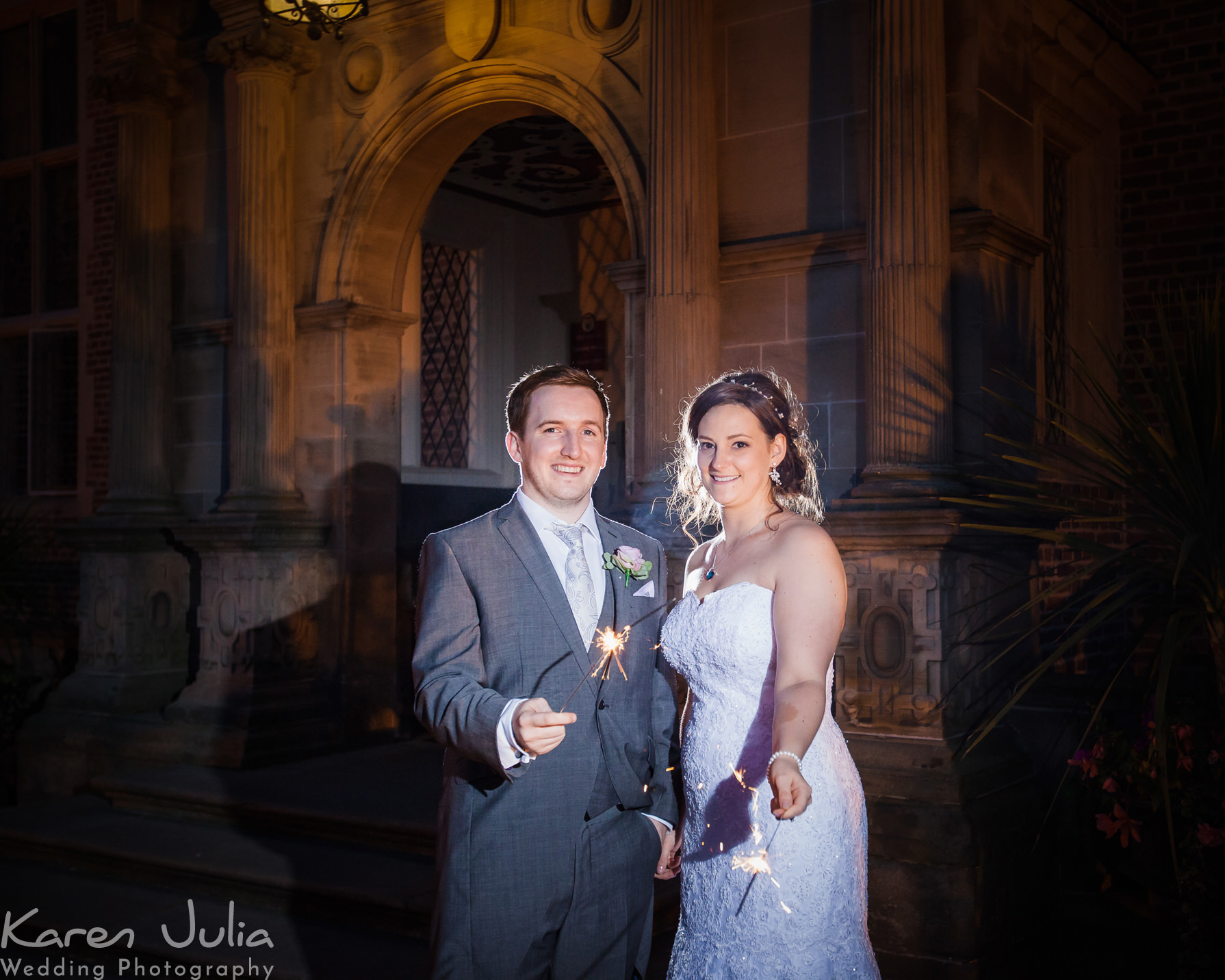 bride and groom with sparklers outside Crewe Hall