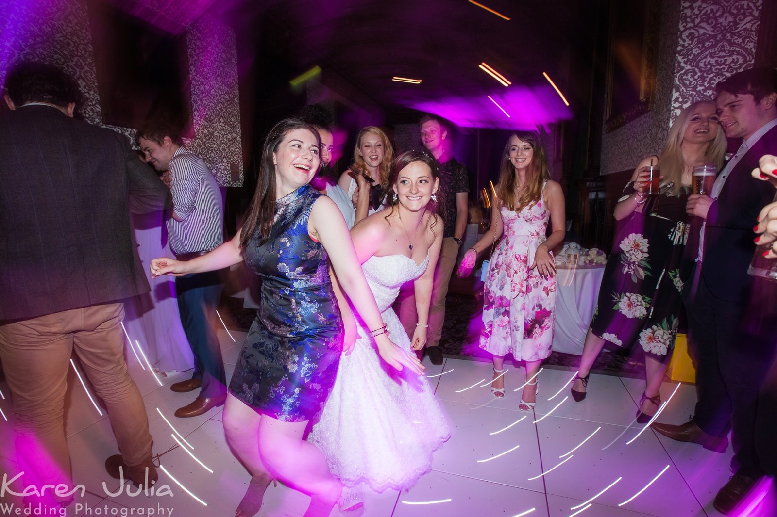 bride on dance floor at Crewe Hall with pink lighting