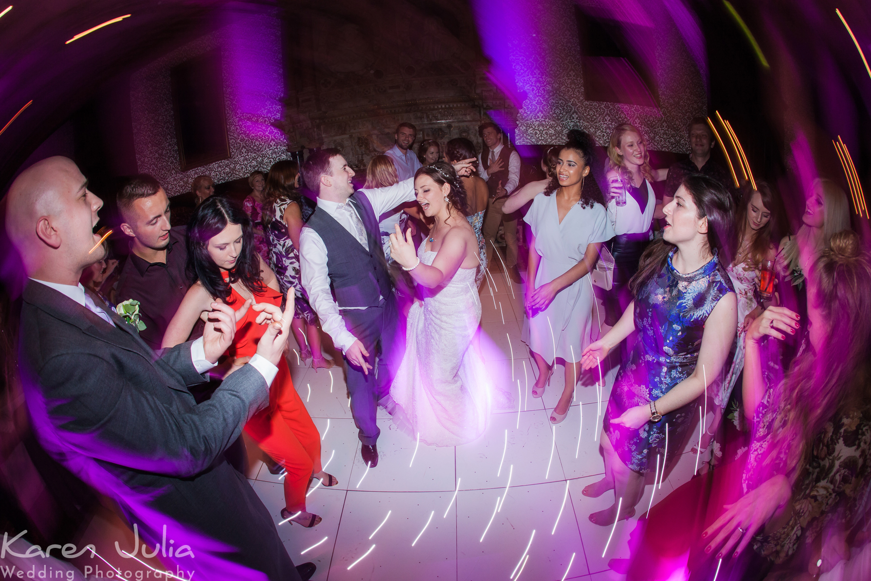 bride and groom on dance floor at Crewe Hall with pink lighting