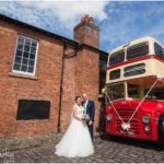 Bride and Groom outside Castlefield Rooms wedding venue with vintage red and cream double decker bus