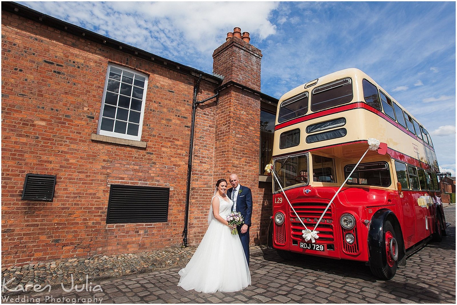 Bride and Groom outside Castlefield Rooms wedding venue with vintage red and cream double decker bus