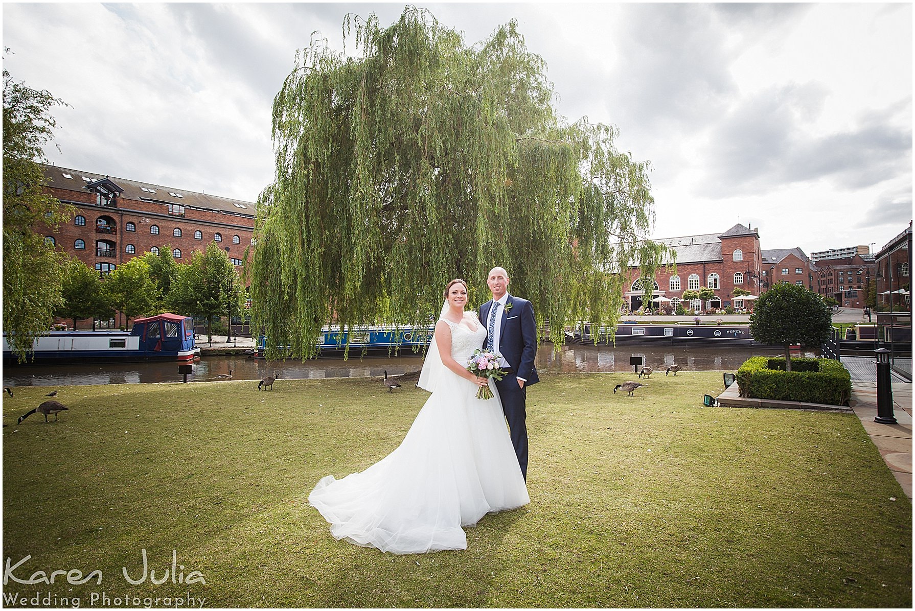 bride and groom pose for portrait on their wedding day in Castlefield