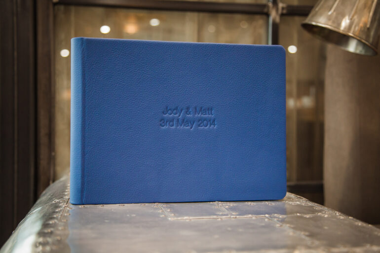 Graphistudio wedding book in blue leather with debossing of names