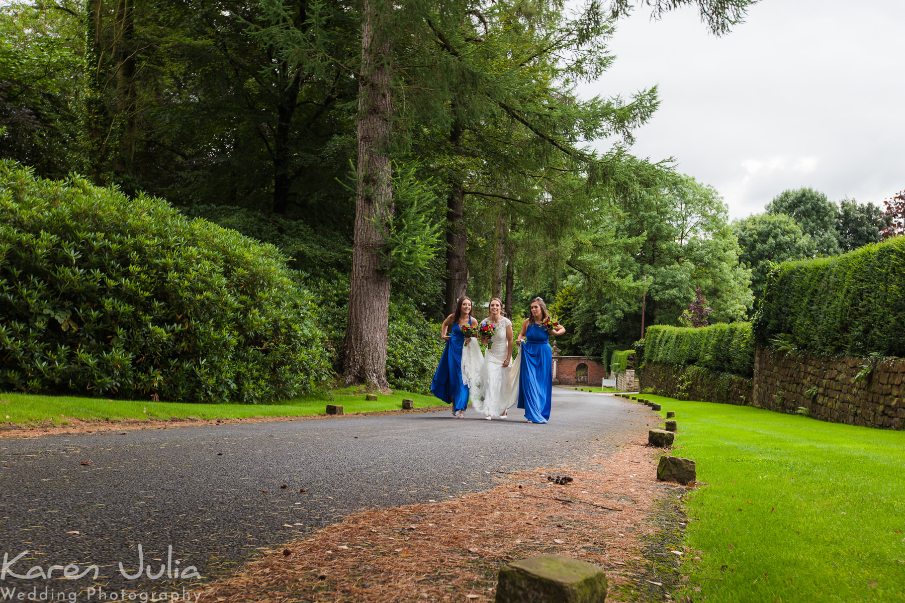 bride and bridesmaids walk to wedding ceremony at Eaves Hall