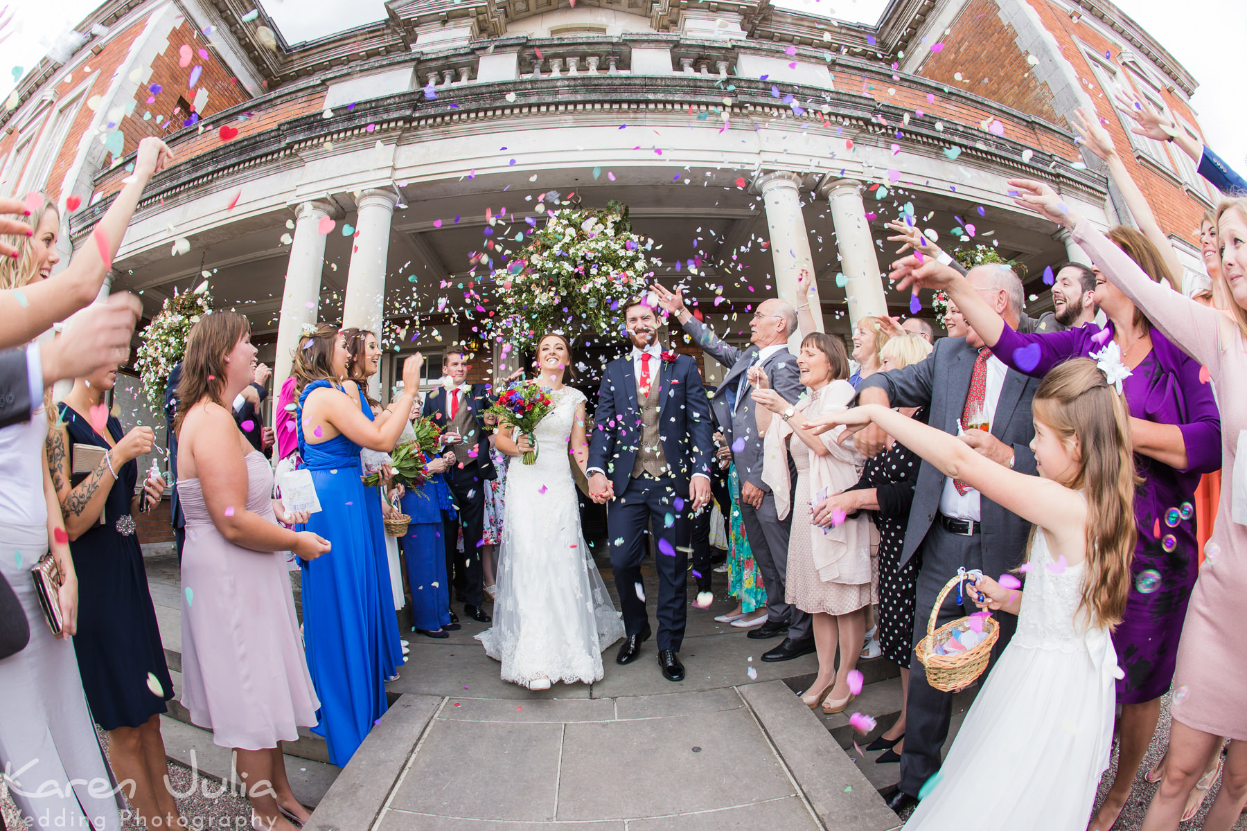 guests throwing confetti at an Eaves Hall Wedding