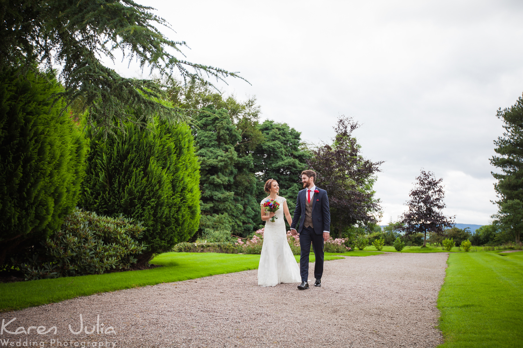 bride and groom on a stroll at their Traditional Wedding at Eaves Hall