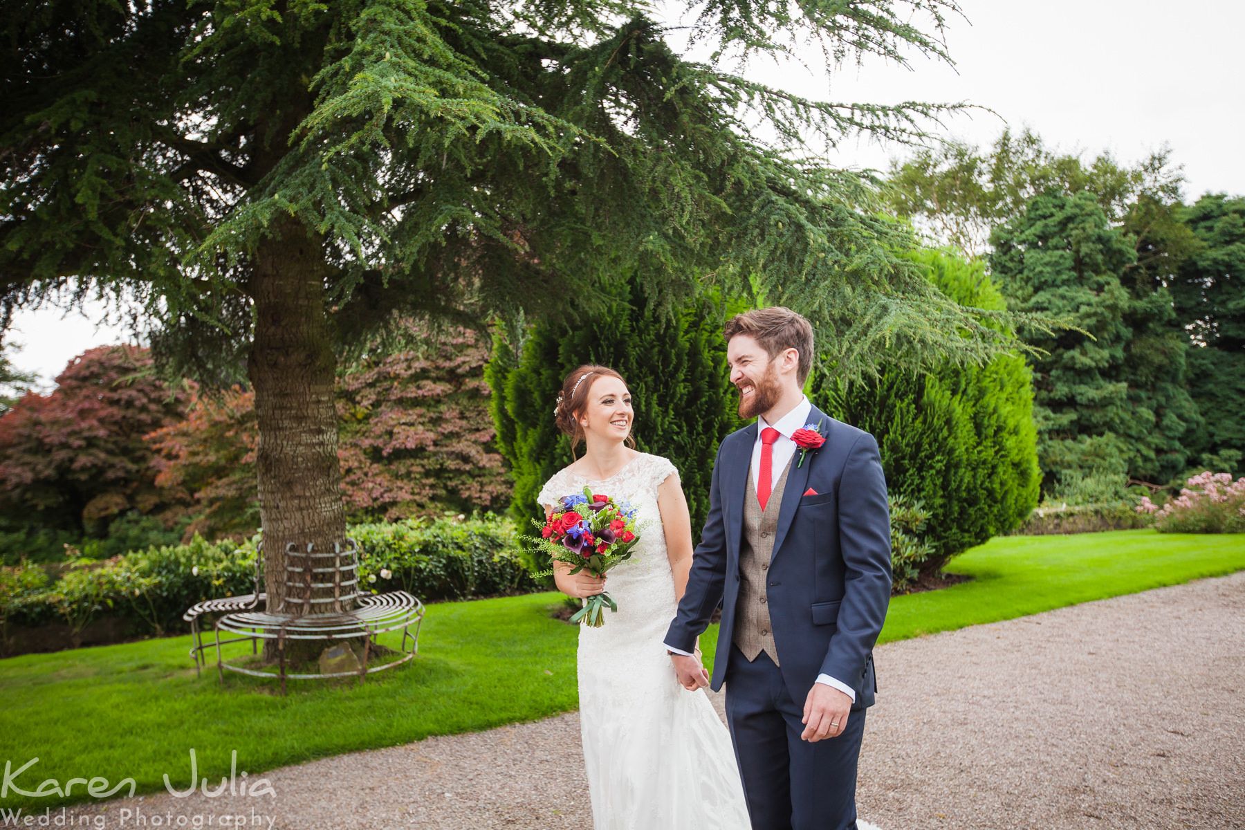 bride and groom strolling in the grounds at Eaves Hall