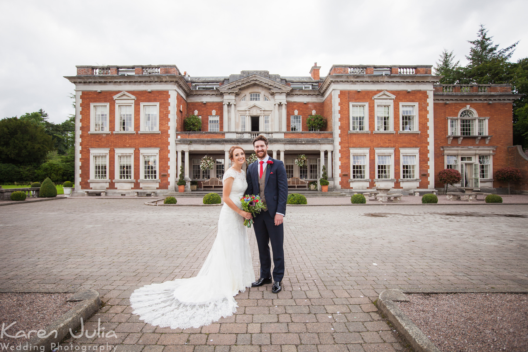 bride and groom portrait in front of Eaves Hall