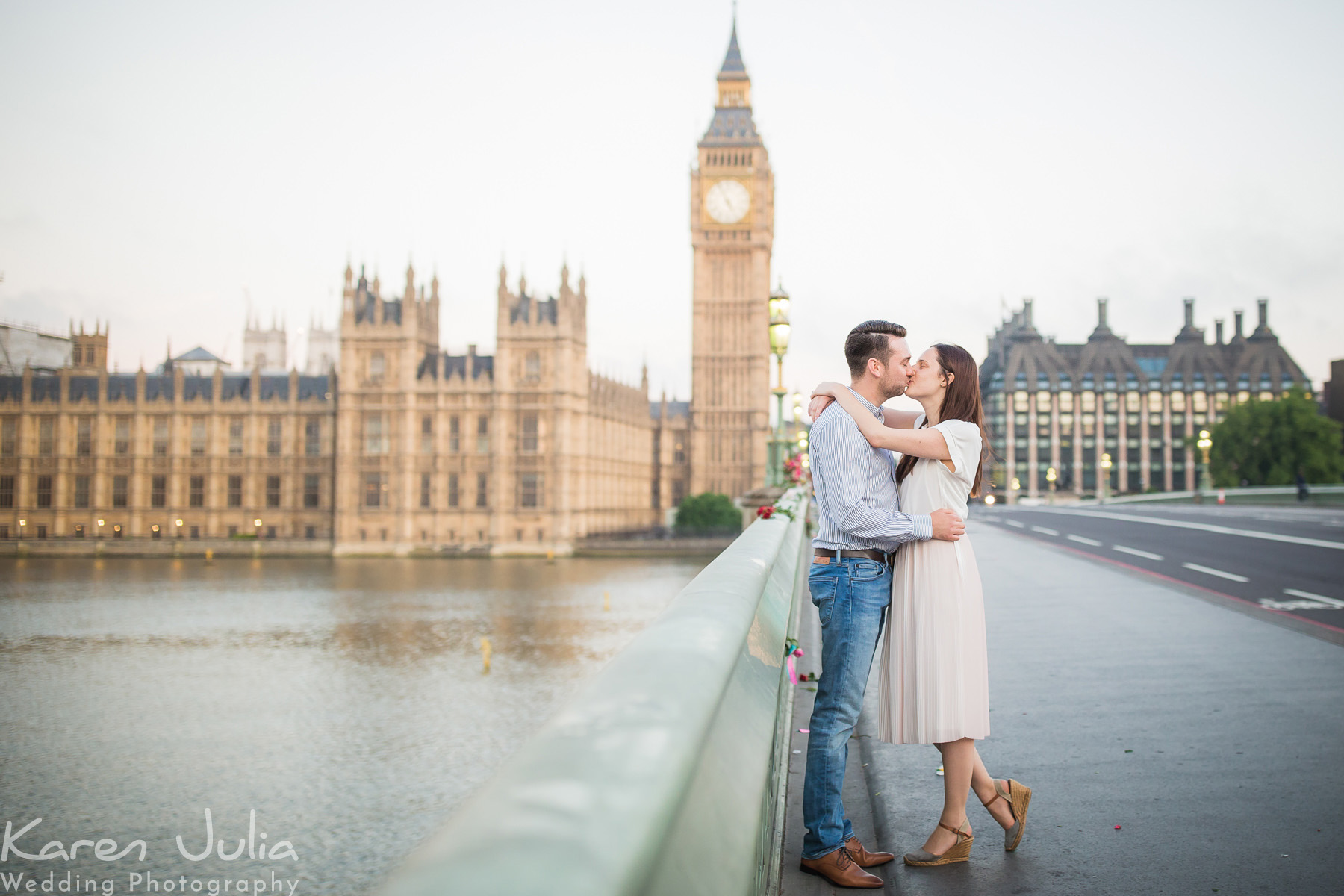 couple embrace on Westminster Bridge during their London Pre Wedding shoot