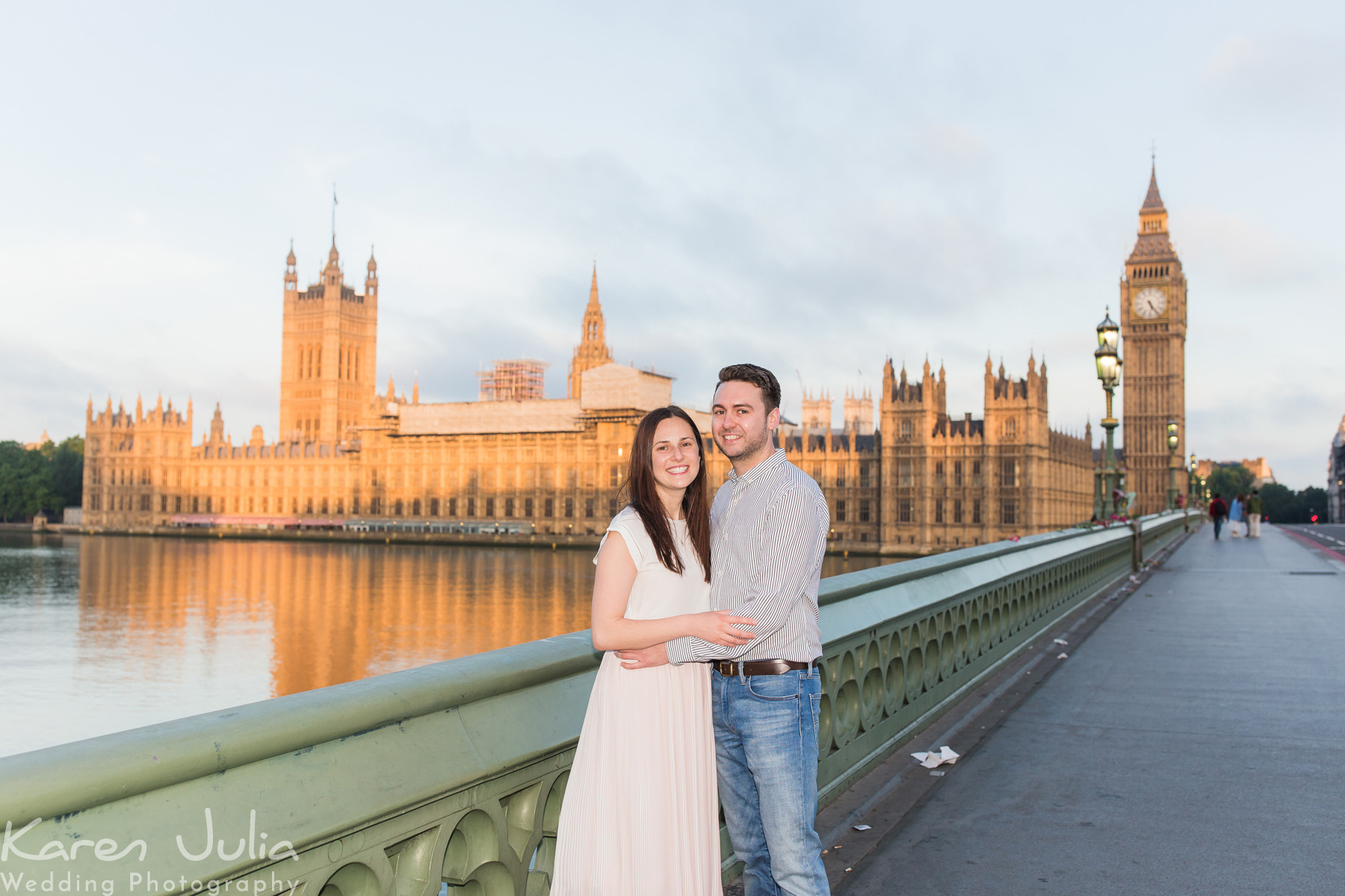couple post for a portrait on Westminster Bridge at sunrise, by Karen Julia Photography