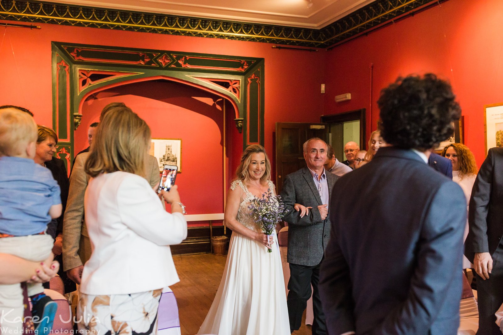 bride walks down the aisle at Didsbury Parsonage