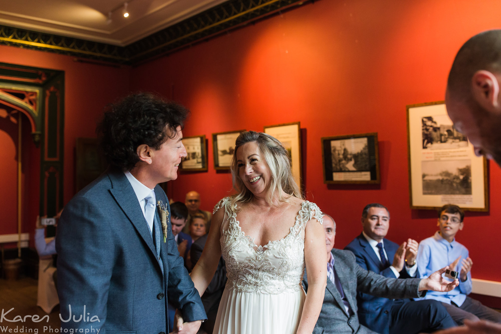 bride and groom smiling at each other at the end of their wedding ceremony in Didsbury parsonage