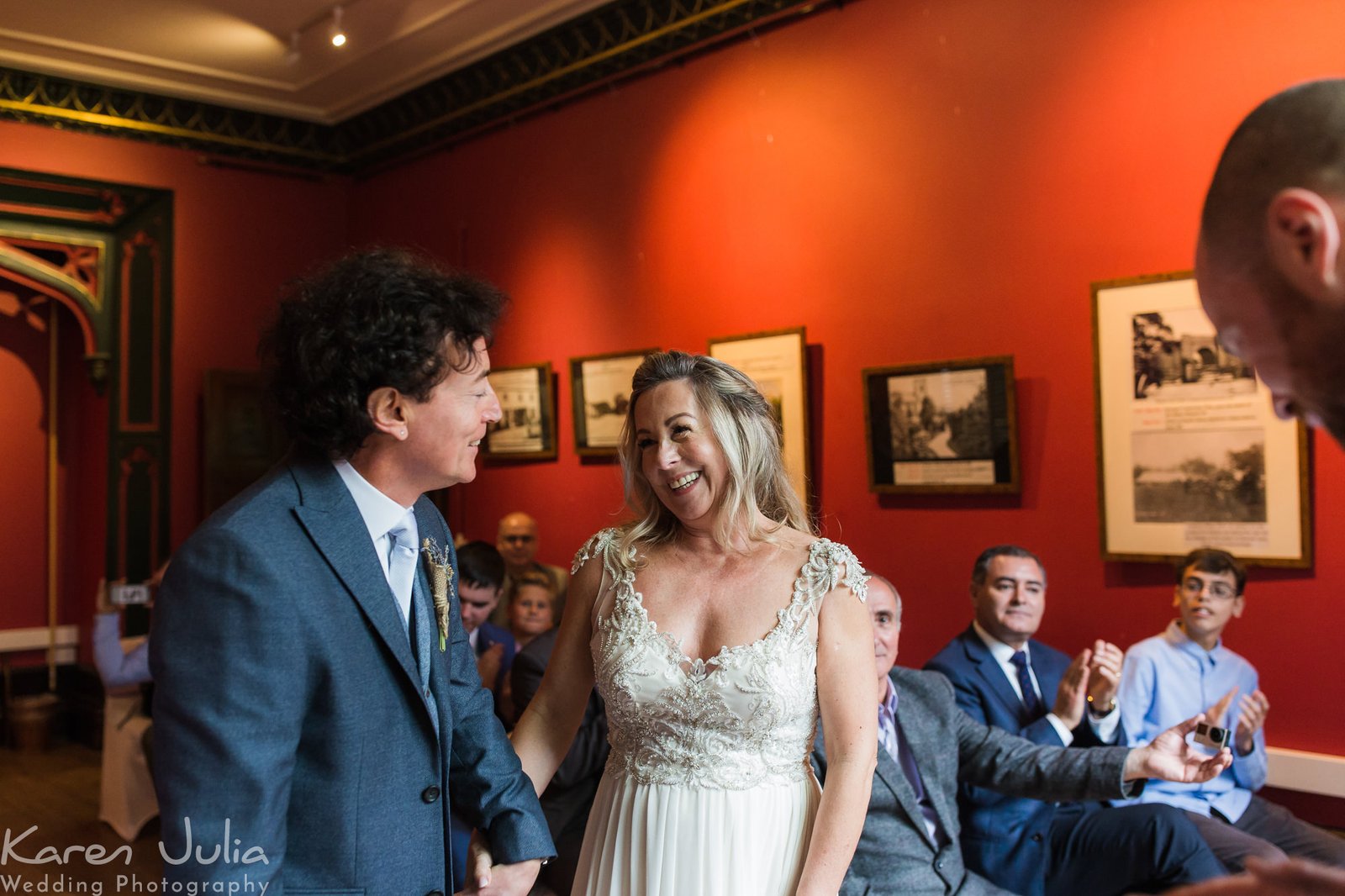 bride and groom smiling at each other at the end of their wedding ceremony in Didsbury parsonage