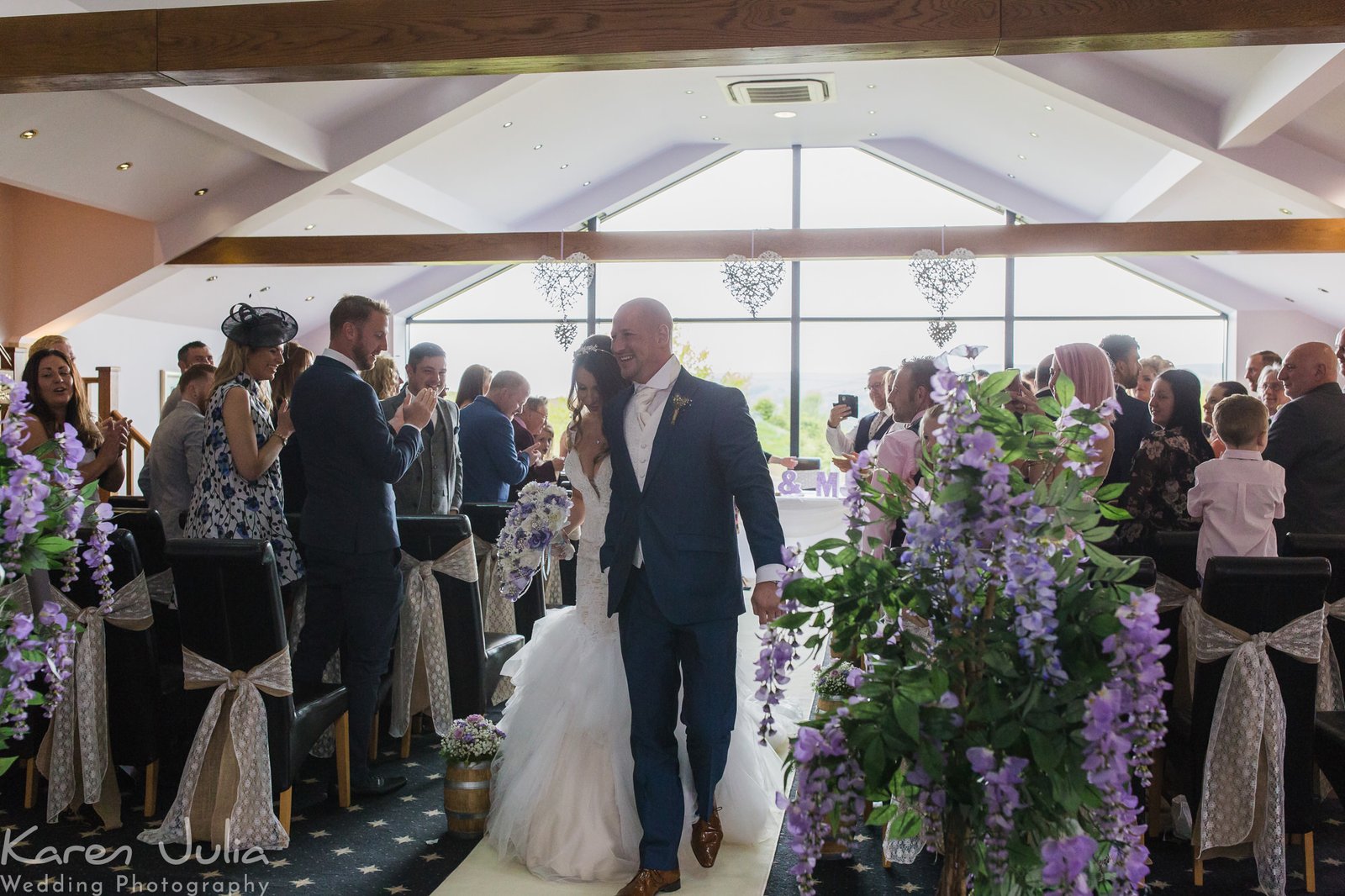 bride and groom walk back up the aisle together after their wedding ceremony