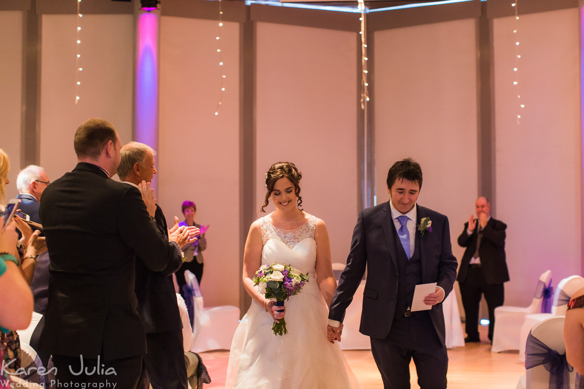 bride and groom walk up aisle together after their wedding ceremony