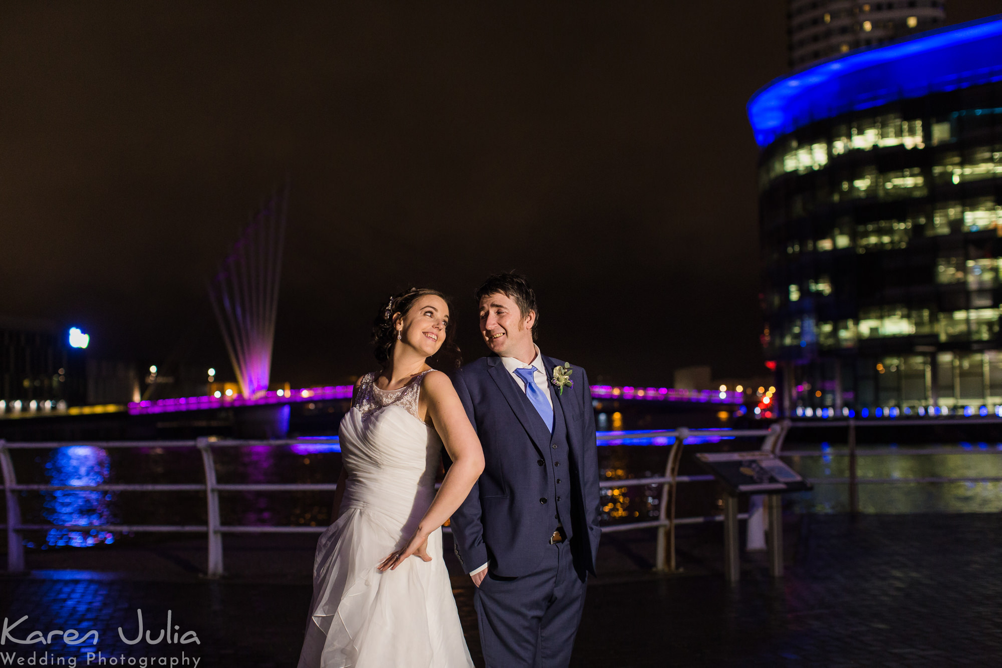 bride and groom portrrait at night behind the Lowry Theatre