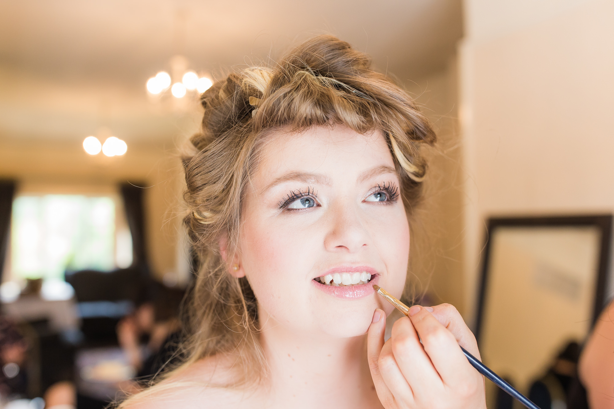 bride has lipstick applied during wedding morning preparations at the Deanwater Hotel