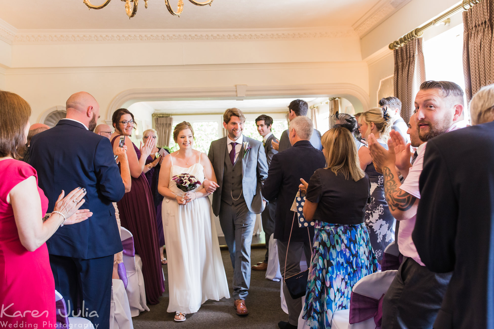 bride and groom walk back up aisle together at their Deanwater Hotel Wedding