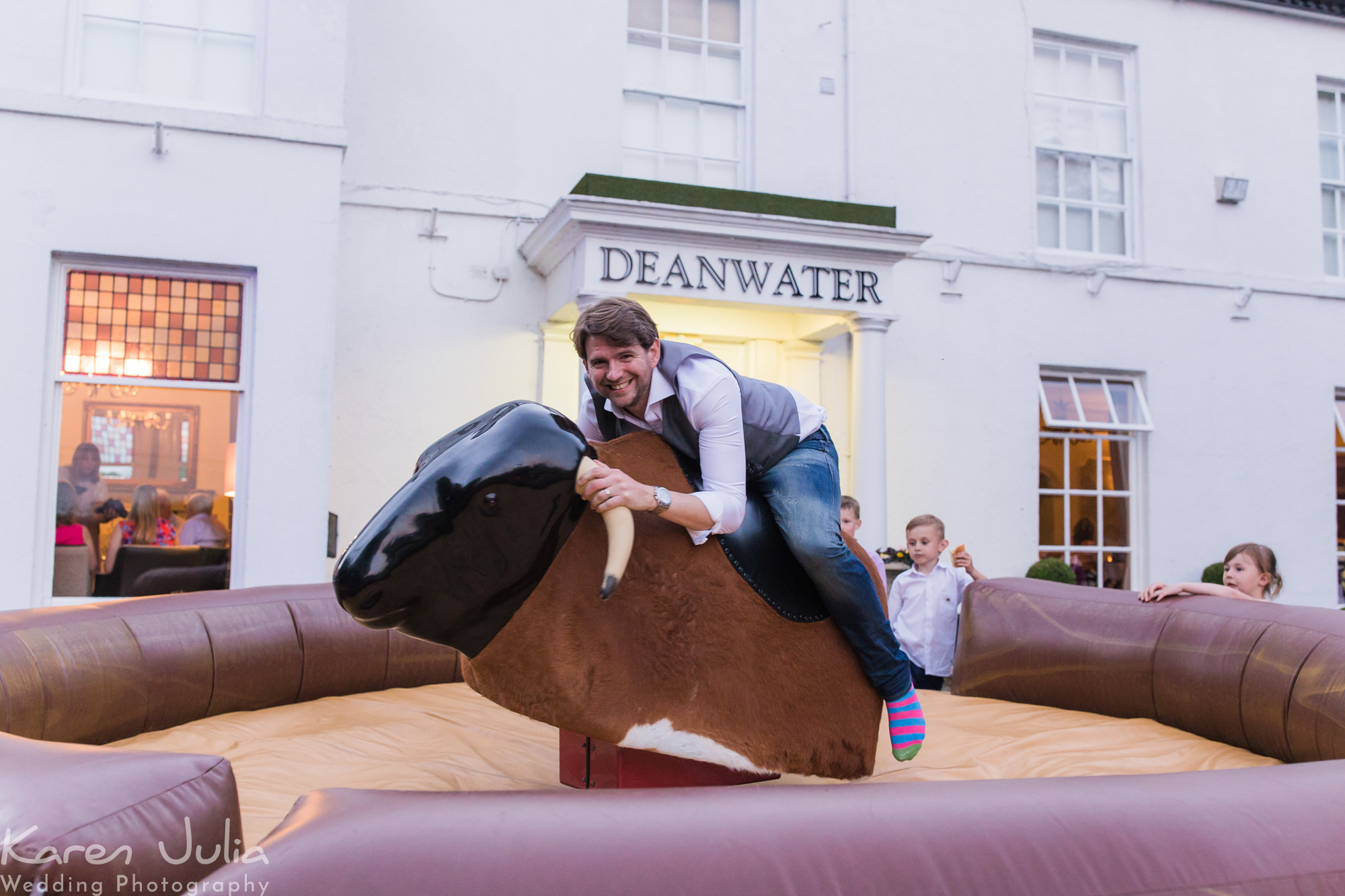groom on rodeo bull outside the Deanwater hotel at wedding reception