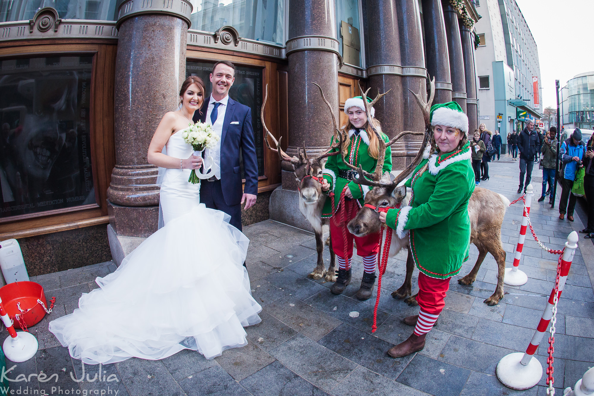 couple portrait with reindeer and elfs outside the hard day's night hotel in Liverpool