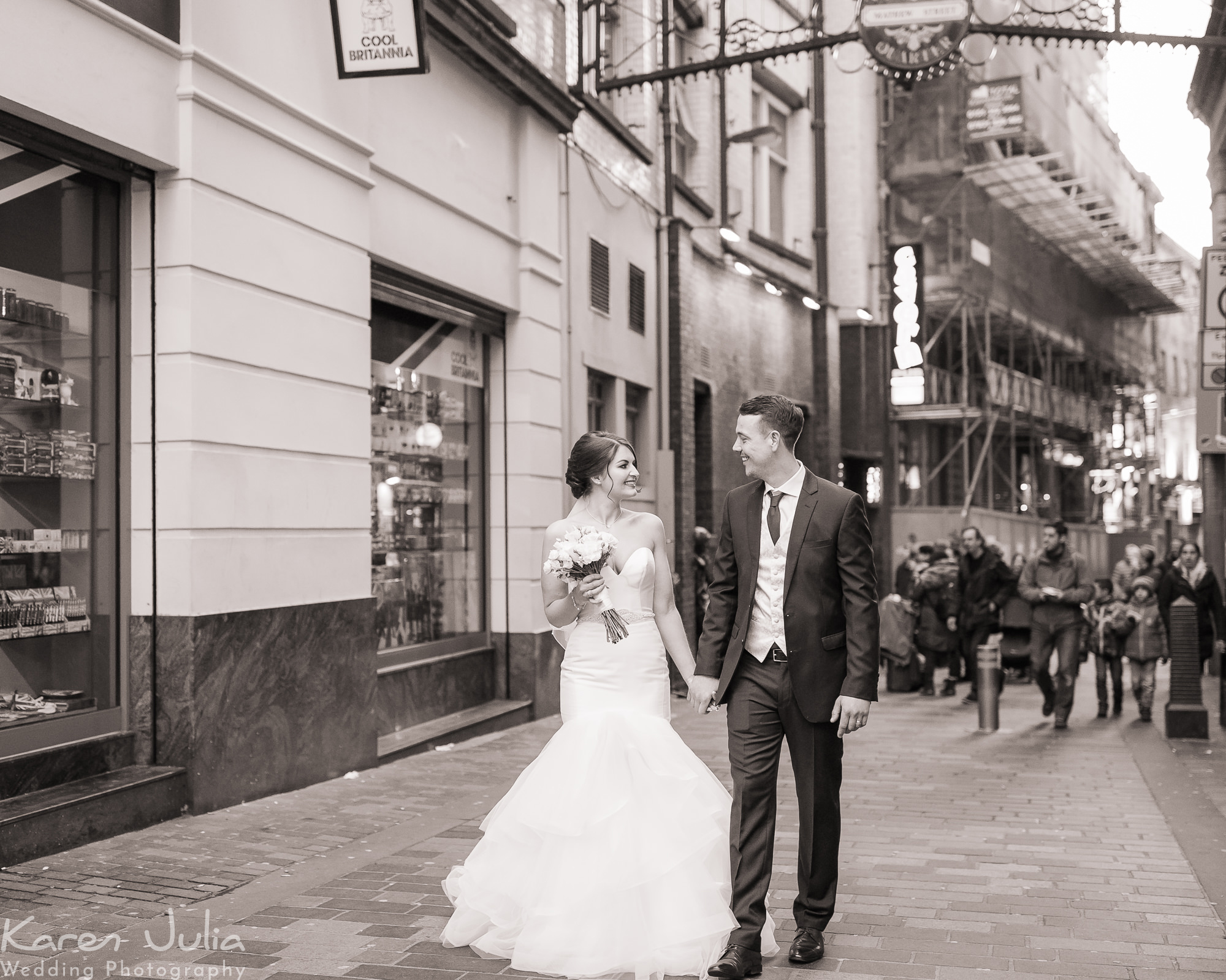couple walk up Matthew Street together after their wedding