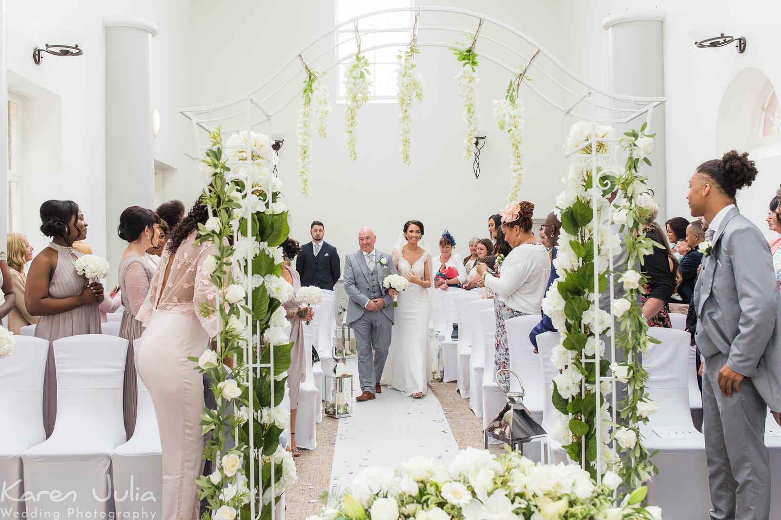 bride and her father walk down the aisle together at Chancellors Hotel