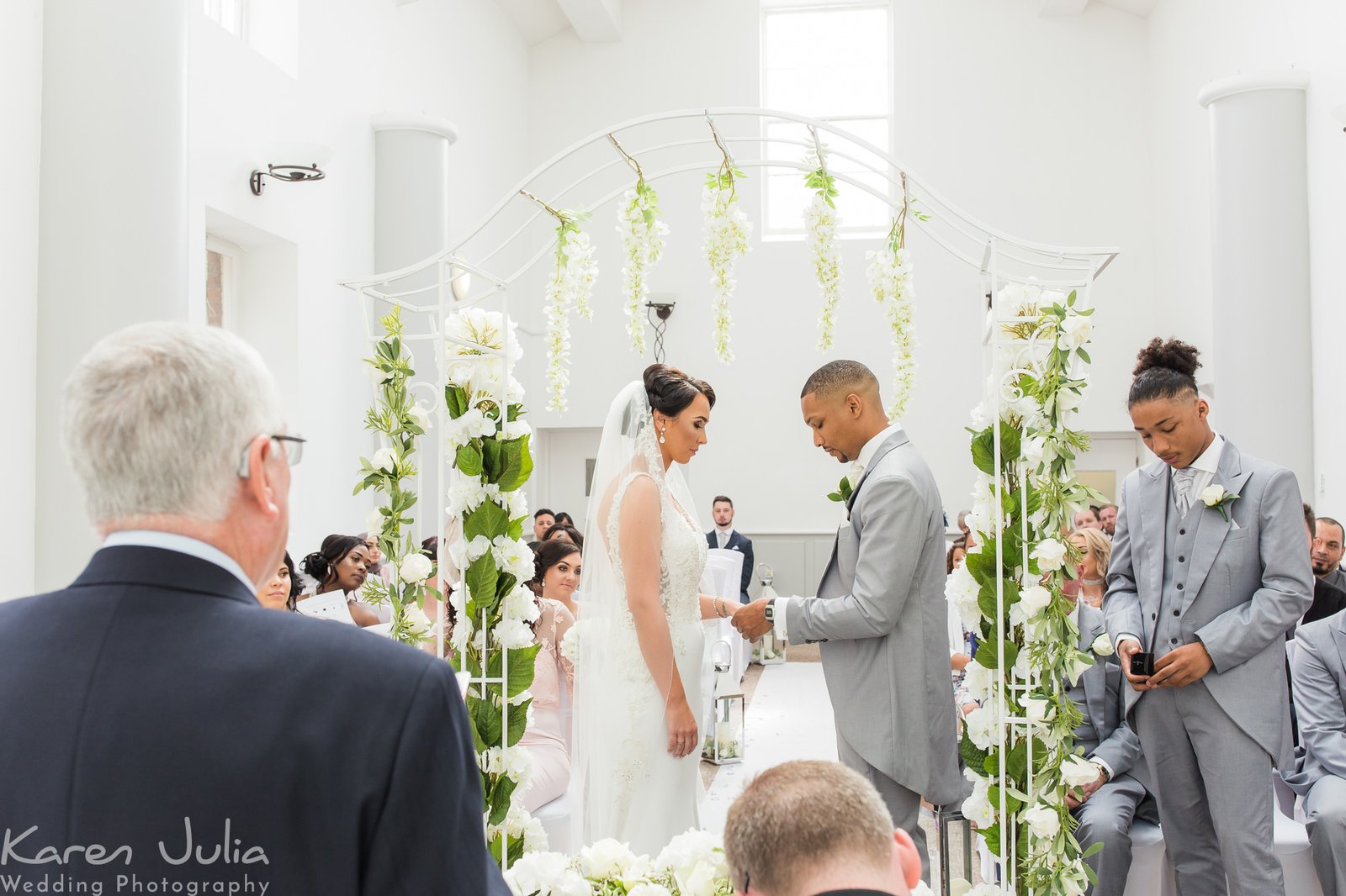 bride and groom exchange rings at their wedding at Chancellors Hotel in Manchester