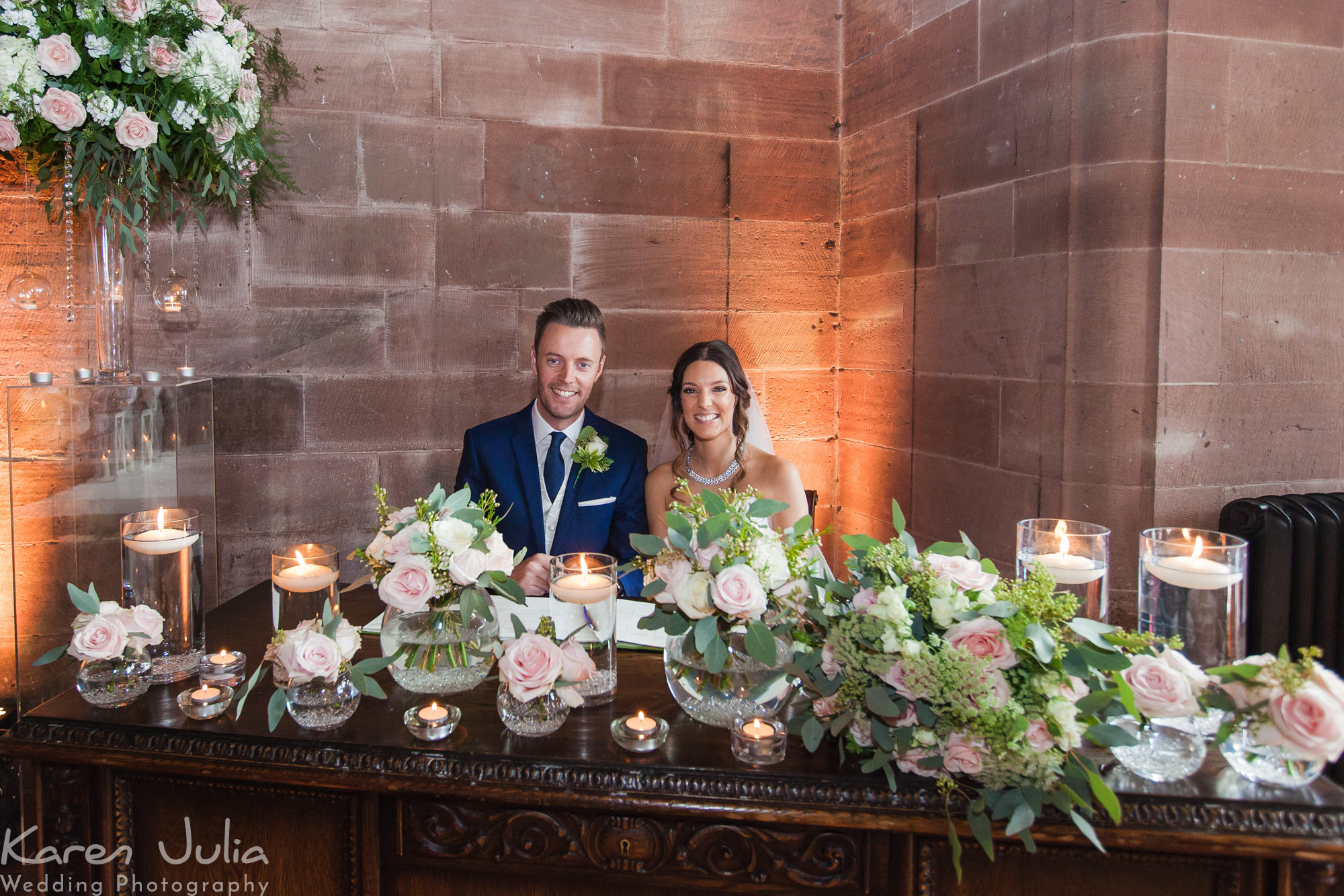 bride and groom pose for a photo in the great hall