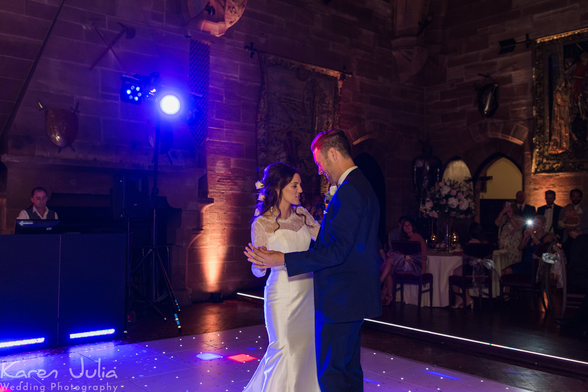 bride and groom have their first dance in the great hall
