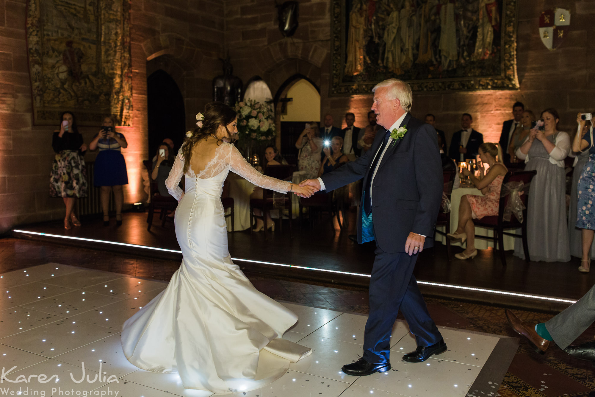 bride dances with her dad in the great hall at Peckforton Castle
