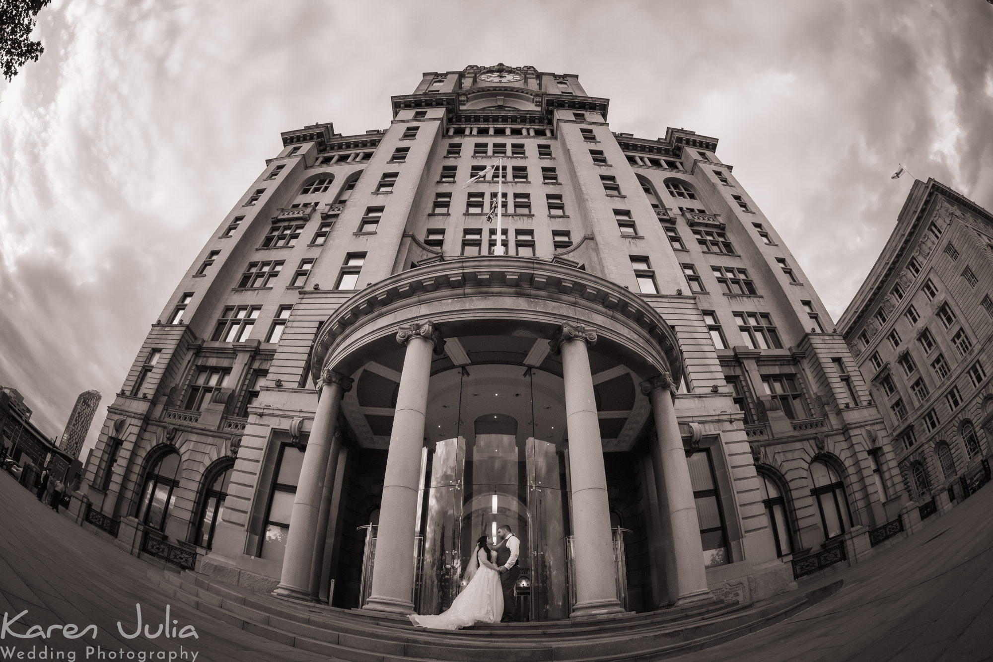 Dramatic wide angle bride and groom portrait outside the Royal Liver building