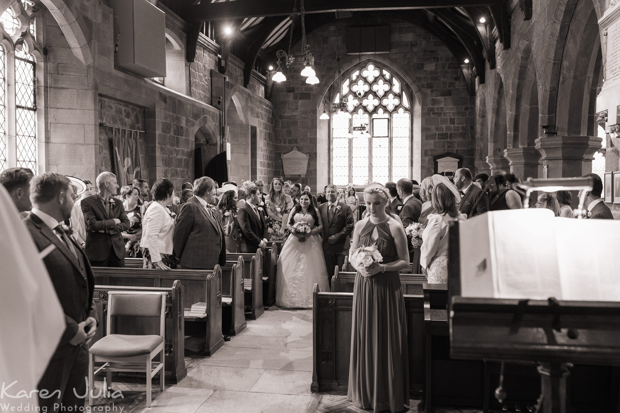 black and white photo of bride walking down the aisle at St Michaels church Aughton